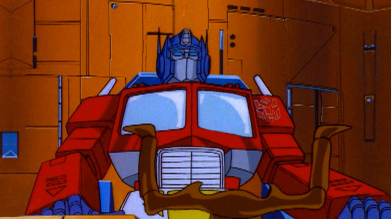 Optimus Prime sitting at the controls of The Ark in The Transformers