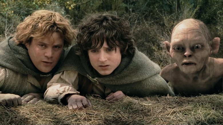 Sam, Frodo, and Gollum huddled together while scouting in The Lord of the Rings: The Two Towers