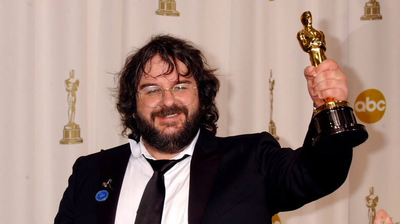Peter Jackson posing with an award