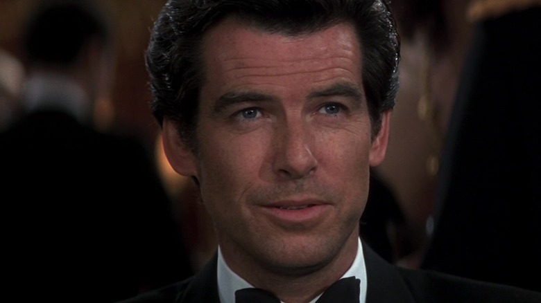 Pierce Brosnan as James Bond sitting at a poker table in GoldenEye