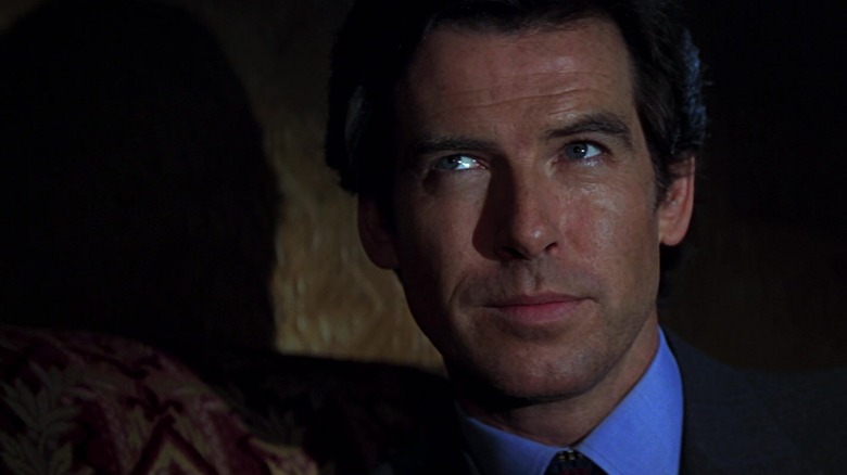 James Bond, sitting at a booth in a shadowy room, a scene from GoldenEye.