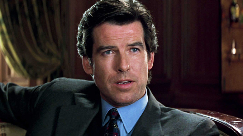 Pierce Brosnan's James Bond sits in an office in a suit in GoldenEye