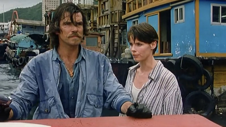 Pierce Brosnan's Mike Graham and Alexandra Paul's Sabrina Carver stand side by side in a marina in Night Watch
