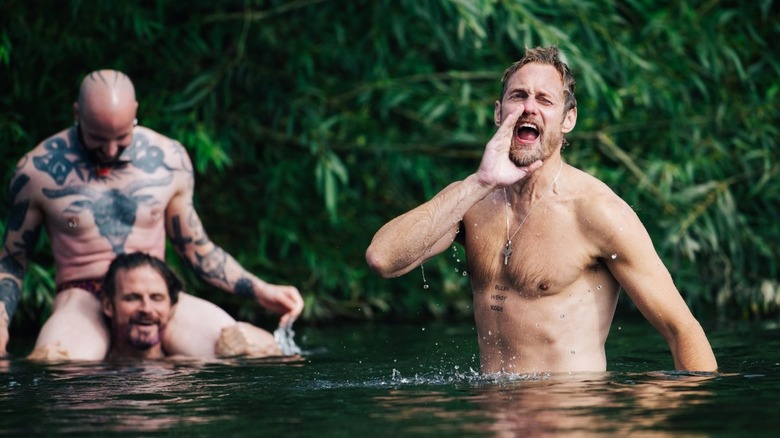 Alexander Skarsgard as Ray in Pillion with bikers in the lake