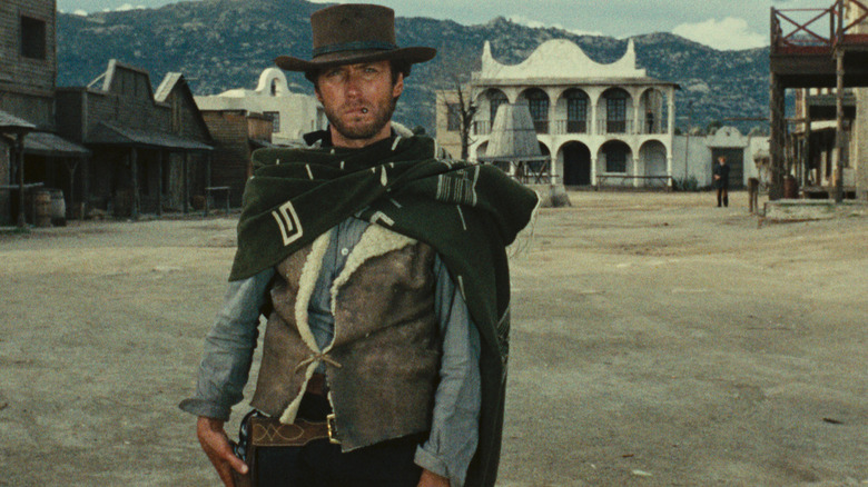 Clint Eastwood grabs gun in A Fistful of Dollars