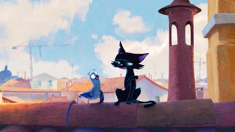 A cat and a bird sitting on a rooftop in Gatto