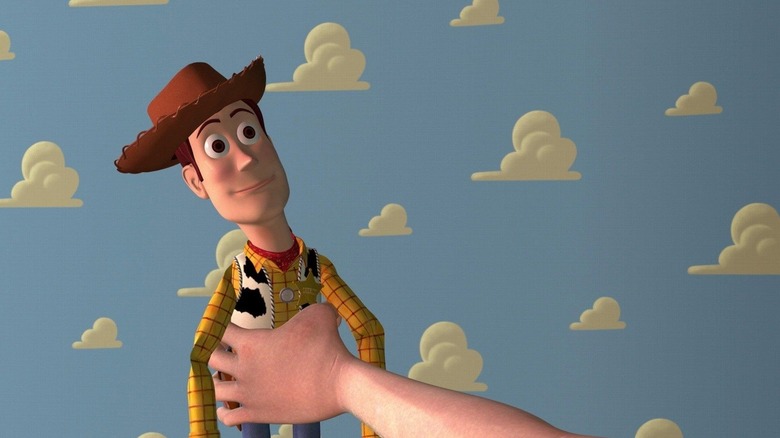 Andy's disembodied hand holding Woody in Toy Story