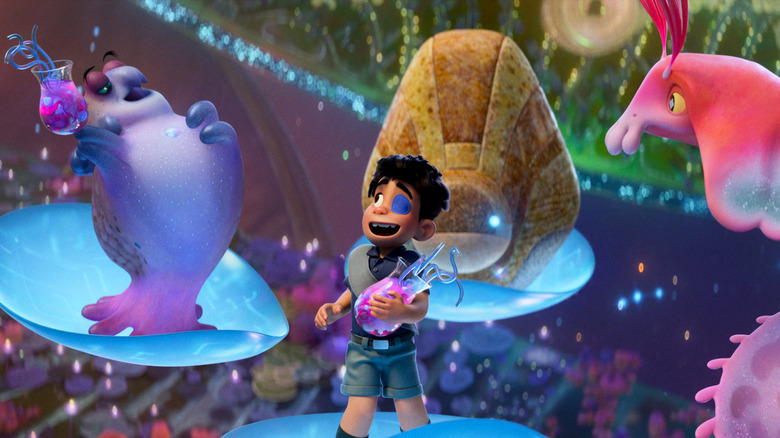 Elio stands among some of the ambassadors of the Communiverse on flying circuit leaf discs