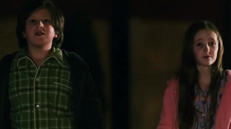 Isak Tufic and Teagan Sucherman as two siblings standing side by side in Pluribus