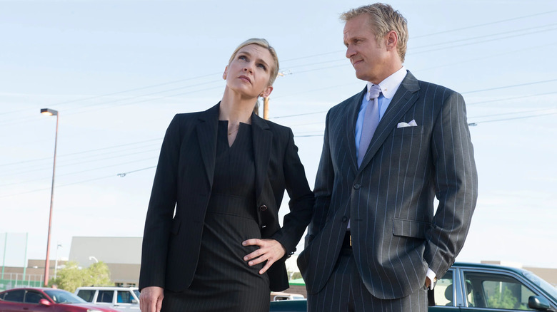 Kim Wexler (Rhea Seehorn) and Howard Hamlin (Patrick Fabian) standing in a parking lot in Better Call Saul