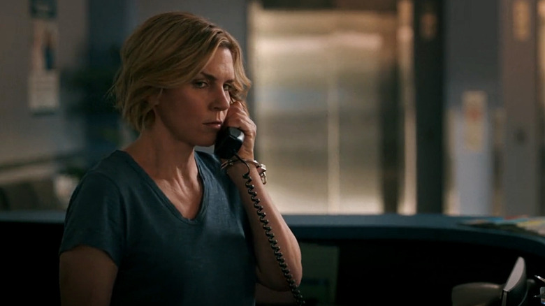 Carol (Rhea Seehorn) listens to a recorded phone message in Pluribus