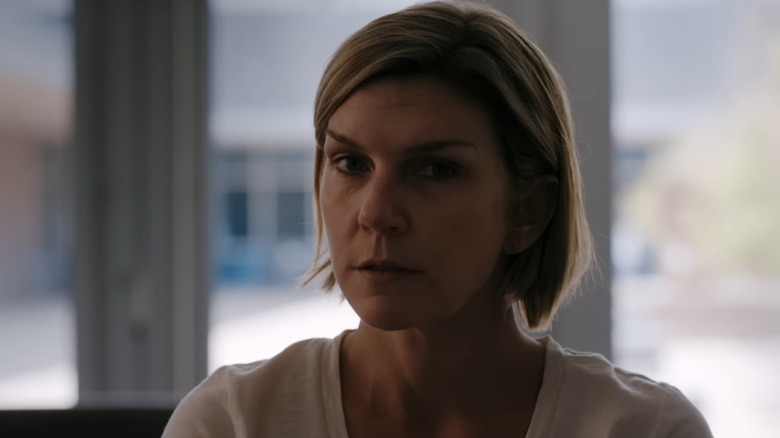Rhea Seehorn as Carol Sturka staring suspiciously at someone off-screen in Pluribus