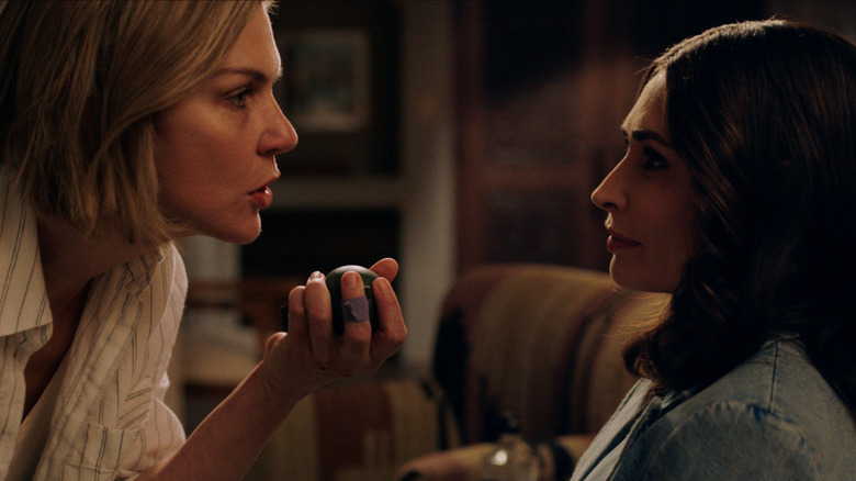 Rhea Seehorn's Carol Sturka brandishing a grenade and facing Karolina Wydra's Zosia on Pluribus