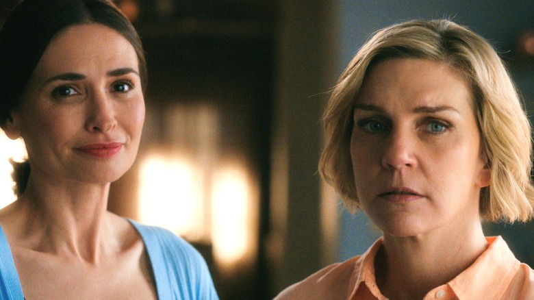 Karolina Wydra as Zosia standing next to Rhea Seehorn as Carol Sturka in Pluribus