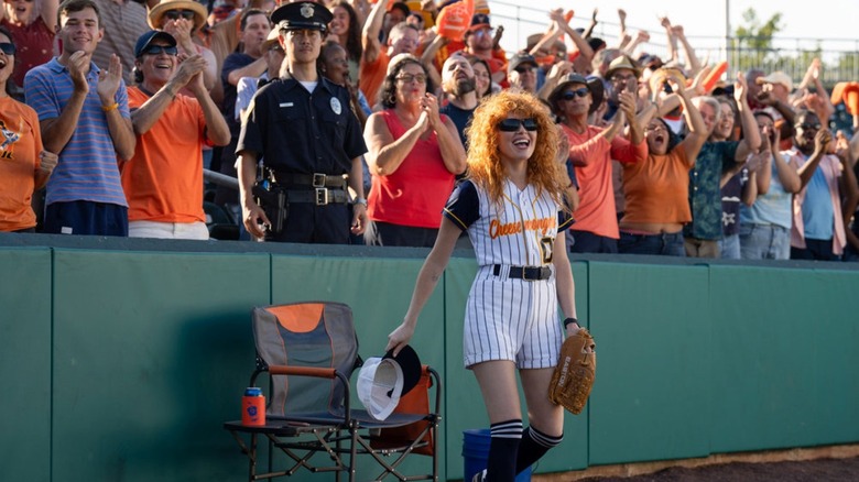 Natasha Lyonne as Charlie Cale dressed as a ball girl during a baseball game in Poker Face