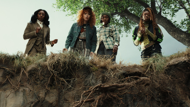 Natasha Lyonne as Charlie Cale and Cynthia Erivo as three identical siblings looking over the side of a cliff in Poker Face season 2