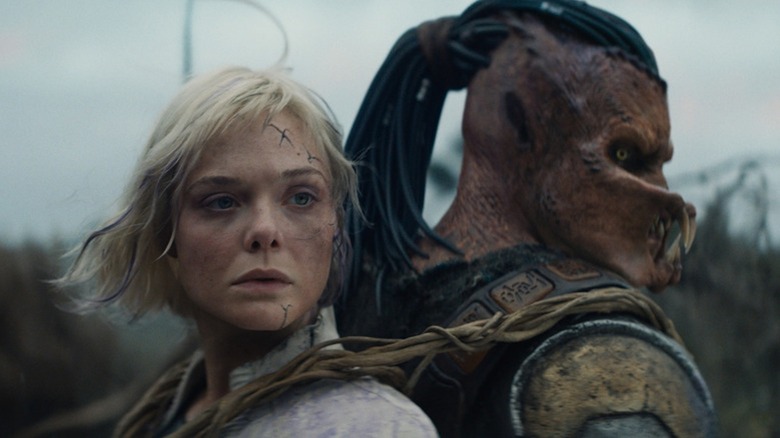 Elle Fanning as Thia and Dimitrius Schuster-Koloamatangi as Dek are bound together in Predator: Badlands