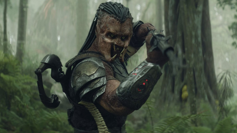 Dek thrusts toward a beastie with his sword in Predator: Badlands