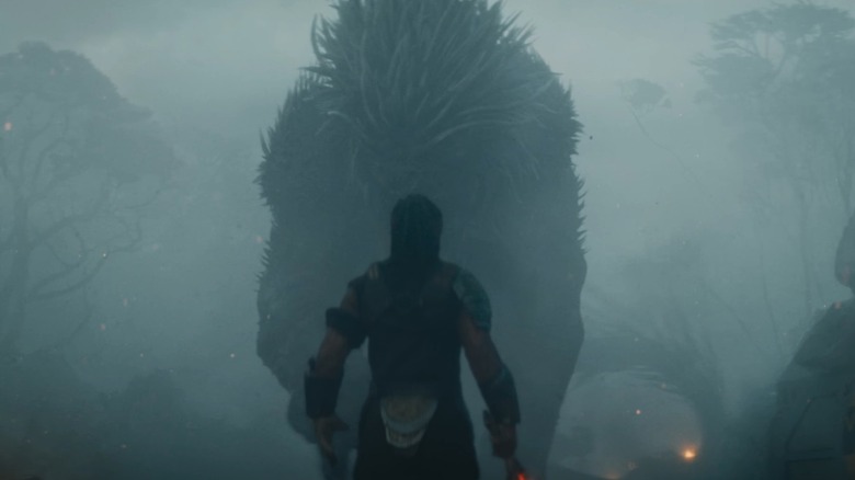 Dek facing down the Kalisk in Predator: Badlands