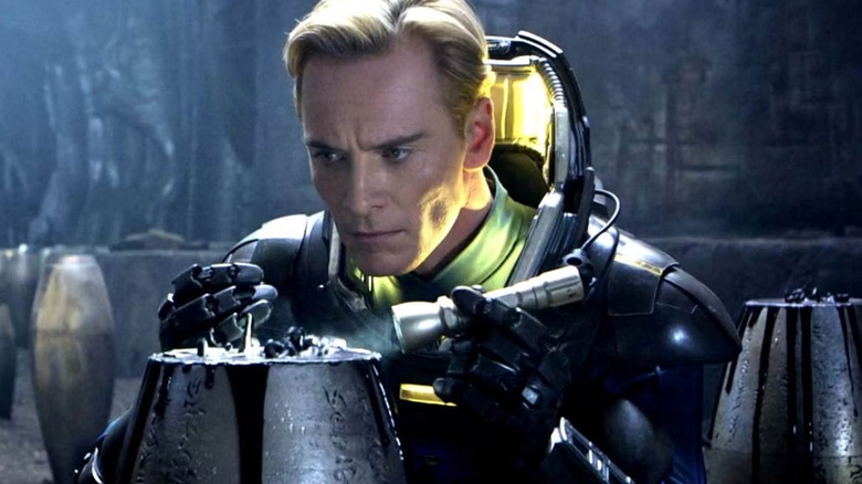 David from Prometheus in a space suit searches for a container