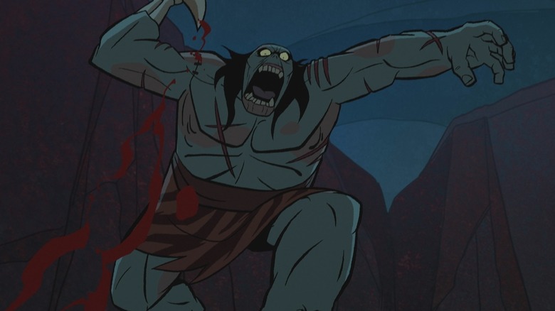 Une lance zombie sur le point d'assassiner viscieusement quelqu'un avec sa main squelette dans Primal