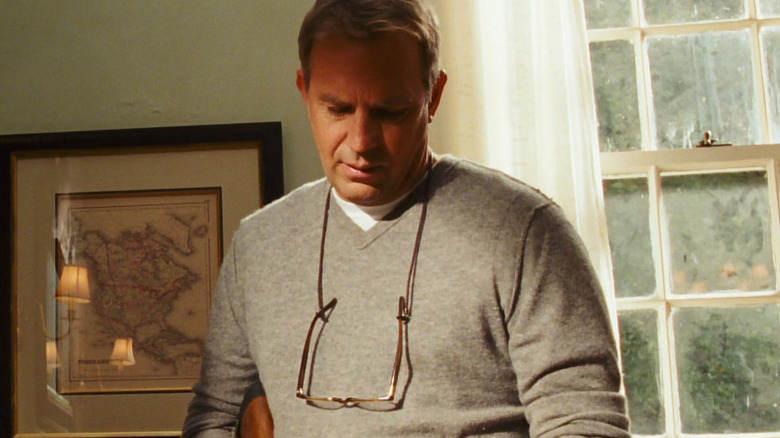 John looking down at his hands in The New Daughter