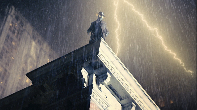 Spider-Noir standing atop a building on a rainy night in Spider-Noir