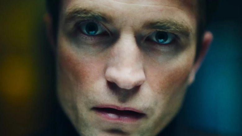 Robert Pattinson's Chris Hansen is seen in closeup against a blurry background in Primetime