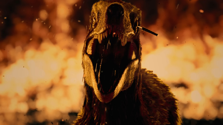 A raptor surrounded by fire with a knife in its eye in Primtive War