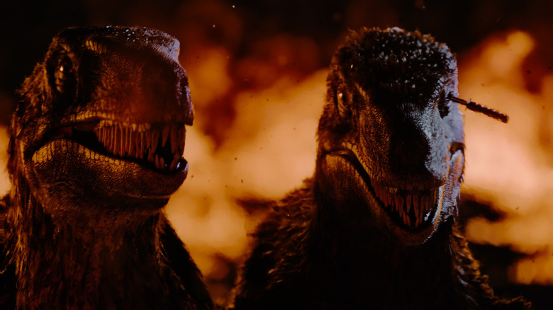 Raptors standing in front of flames in Primitive War