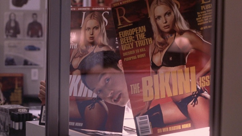 A magazine editor looking between two giant proofs in Vanilla Sky