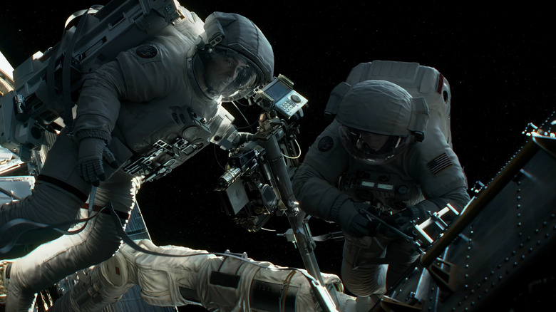 George Clooney's Matthew Kowalski and Sandra Bullock's Dr. Ryan Stone work on the outside of their space shuttle in Gravity