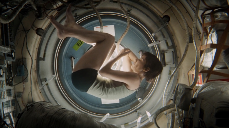Sandra Bullock's Dr. Ryan Stone lays suspended in her space shuttle in Gravity