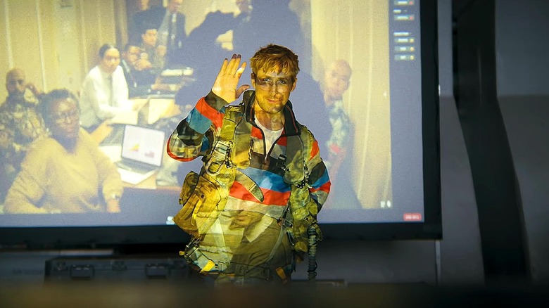 Ryan Gosling as Ryland Grace in front of a screen projector in Project Hail Mary