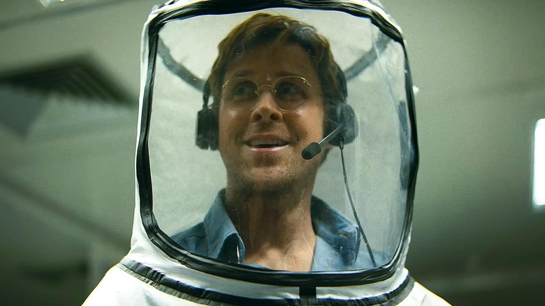 Ryan Gosling as Ryland grace smiling in a hazmat suit in Project Hail Mary