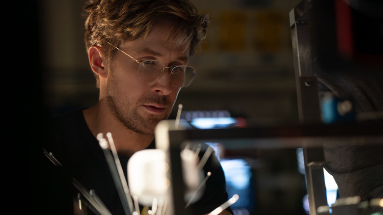 Ryan Gosling as Ryland Grace working at a lab station in Project Hail Mary