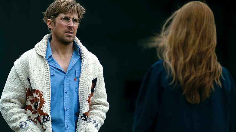 Ryan Gosling as Ryland Grace standing opposite of Sandra Hüller outside on a windy day in Project Hail Mary