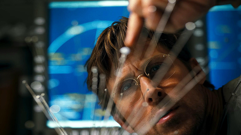 Ryan Gosling as Ryland Grace staring at a model of the solar system in the foreground in Project Hail Mary