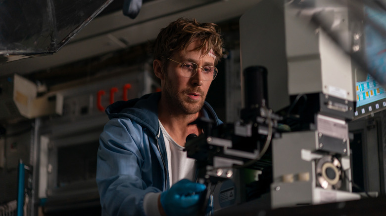 Ryan Gosling as Ryland Grace using a microscope in Project Hail Mary