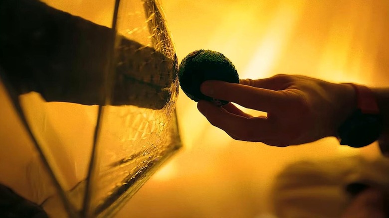 Grace hands Rocky a hacky sack