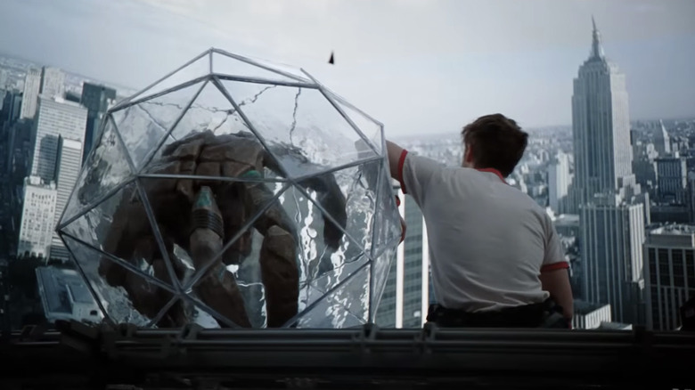 Ryan Gosling as Ryland Grace sitting in the ship's viewing room with Rocky in his little prism ball in Project Hail Mary