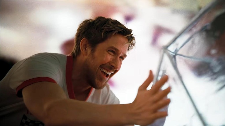 Ryan Gosling as astronaut Ryland Grace embracing a cage containing his alien friend