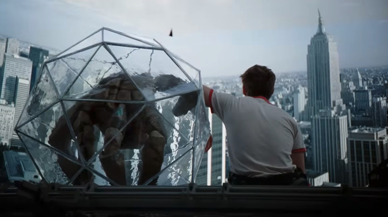 Rocky in his ball and Grace looking at a panorama of a city in Project Hail Mary