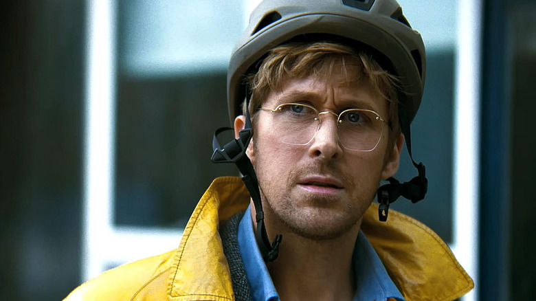 Ryan Gosling as Ryland Grace shrugging sitting at the table in Project Hail Mary