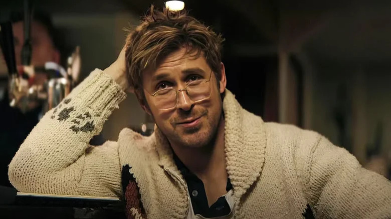 Ryan Gosling's Rylan Grace smiles as he sits down in Project Hail Mary