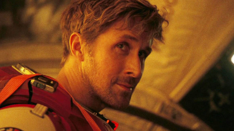 Ryan Gosling's Rylan Grace looks over his shoulder as he stands by an air lock in Project Hail Mary