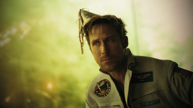Ryan Gosling's Ryland Grace sits wearing a party hat in Project Hail Mary.jpg