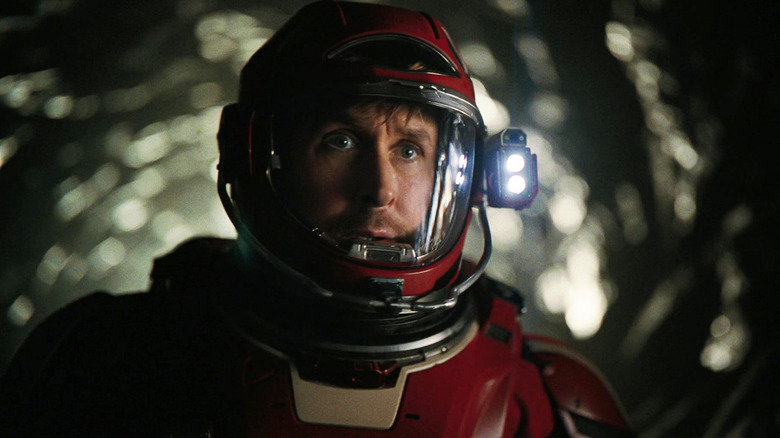 Ryan Gosling's Ryland Grace looks out of his helmet's visor as he stands in a tunnel in Project Hail Mary