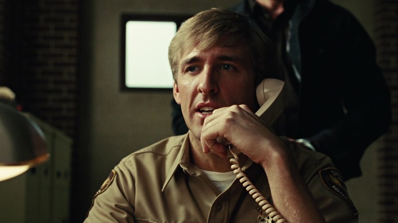 Anton Chigurh approaching a victim on the phone in No Country for Old Men