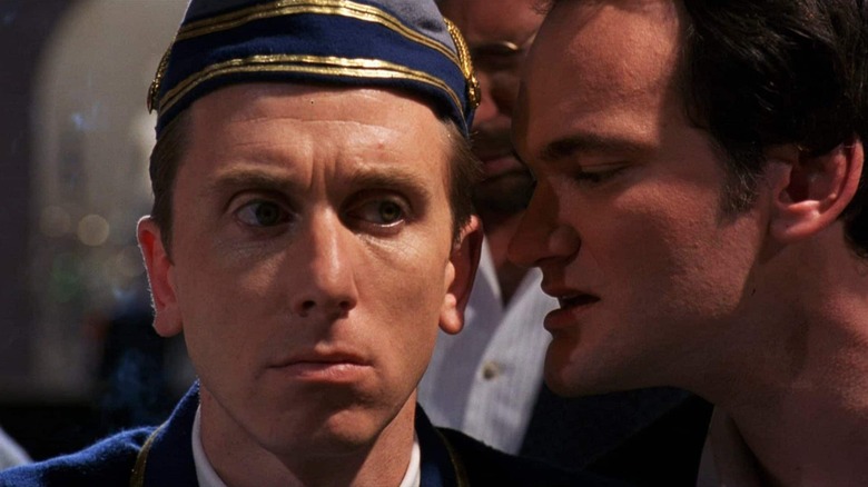 Chester Rush whispering in the Bellboy's ear in Four Rooms